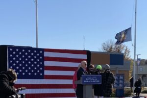 Joe Biden at a podium in front of a flag