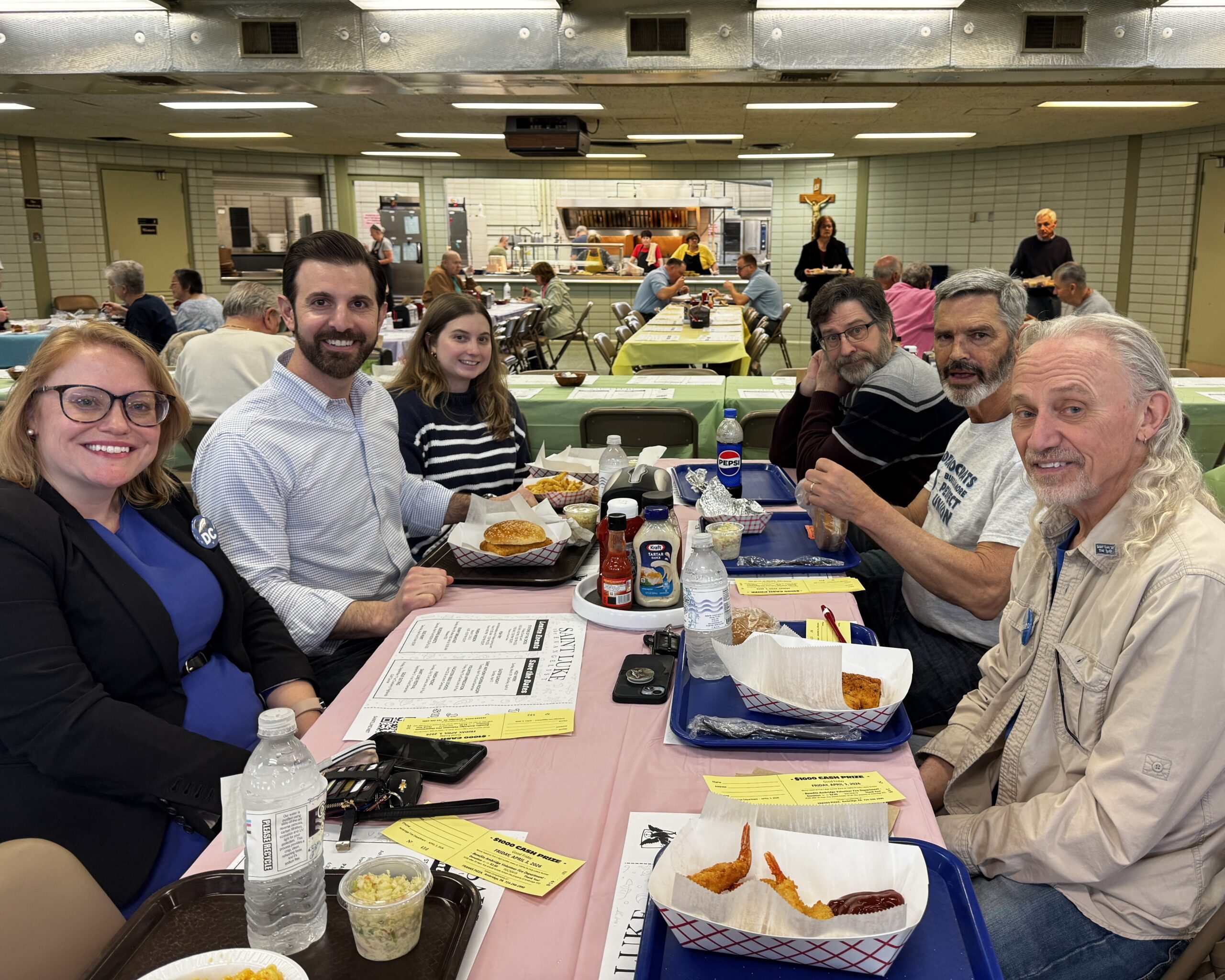 6 people eating a meal in a cafeteria